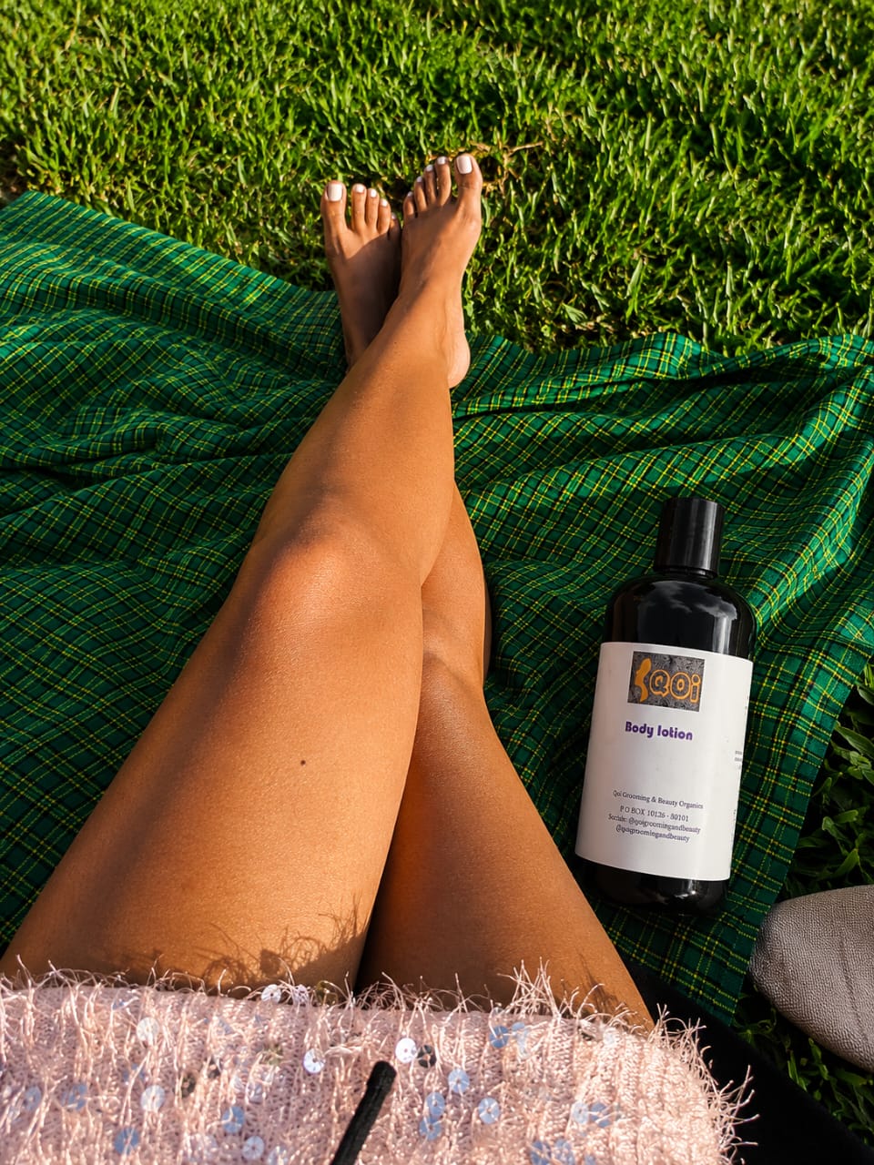 QOI natural body care product beside fresh greenery